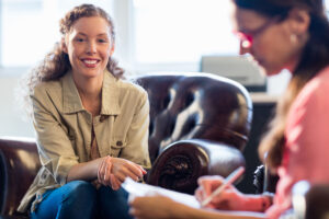 behavioral health specilaist talking to young woman about the importance of relapse prevention in maintaining recovery