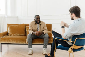 therapist talking to young man in an office setting about the 8 tips on how to get someone into drug treatment