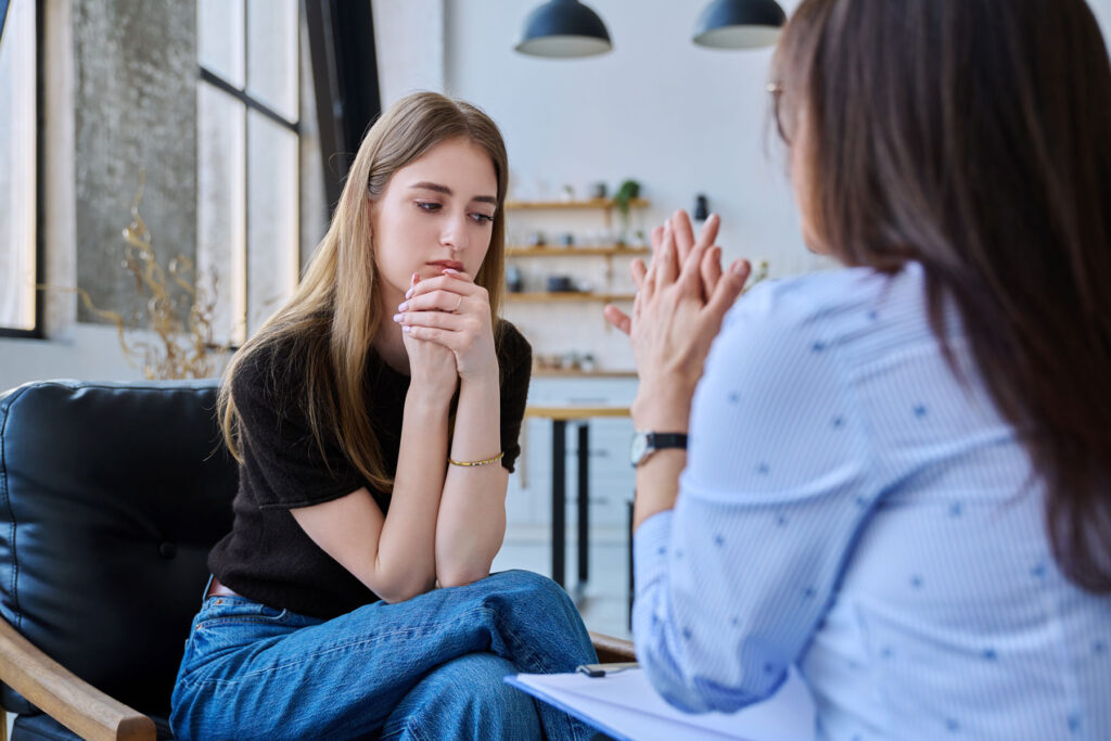therapist tellng young woman about effective addiction therapy exercises for healing and growth