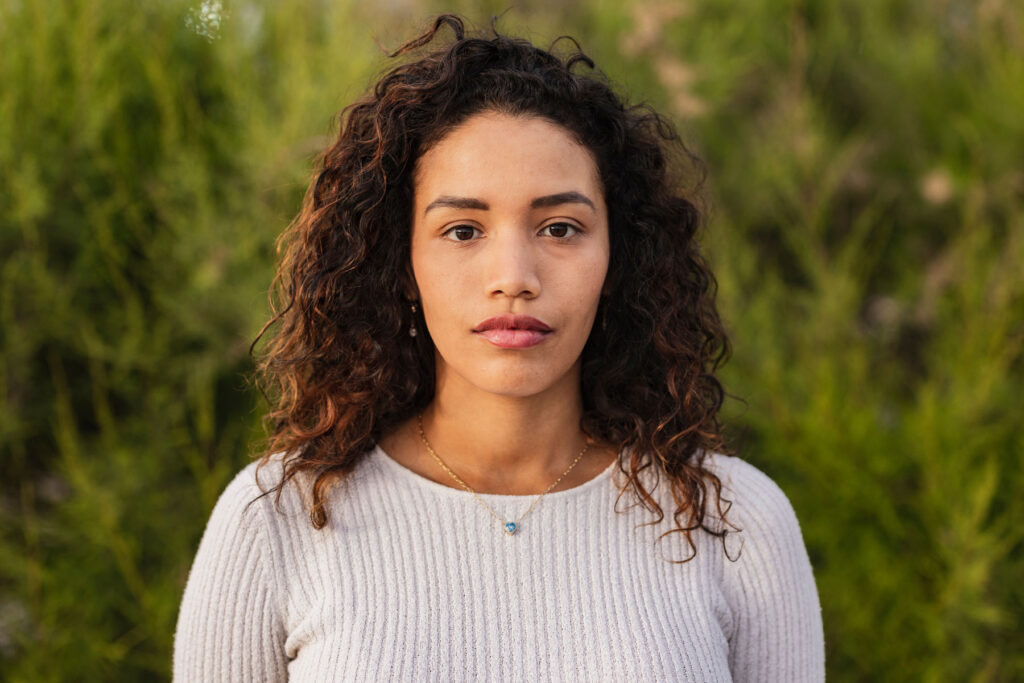 serious looking young woman reflecting on understanding the link between substance abuse and mental health.